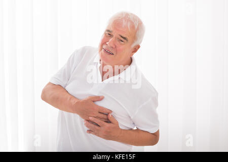 Man With Hand On Chest Suffering From Heart Attack Stock Photo