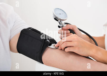 Close-up Of A Doctor Checking Blood Pressure Of Patient Stock Photo