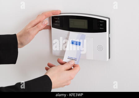 Close-up Of Woman Hand Holding Keycard To Open Door Stock Photo