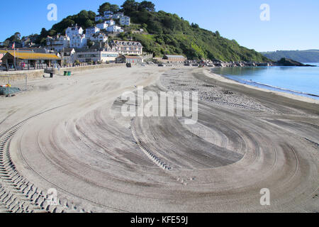 cleaning the beach at looe on the south cornwall coast Stock Photo