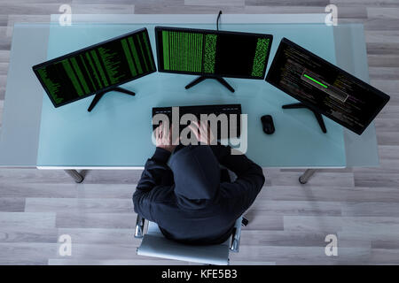 High Angle View Of Hacker Stealing Information From Multiple Computers Stock Photo