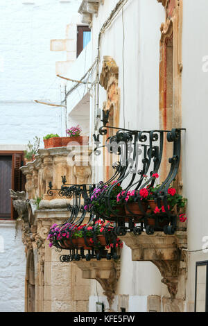 Beautiful street in small medieval whitewashed town Locorotondo, Puglia (Apulia), Bari region, Italy Stock Photo