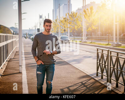 Attractive young man portrait in city street Stock Photo
