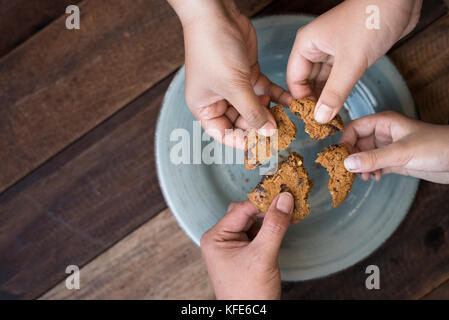 sharing concept - family sharing cookies Stock Photo