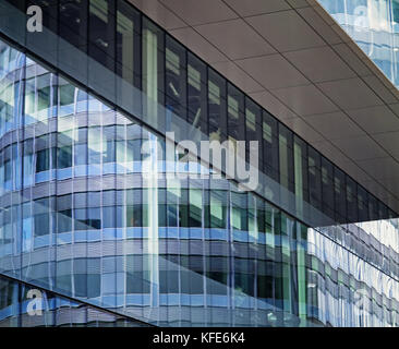 A curved building reflected in glass at Spinningfields, Manchester Stock Photo