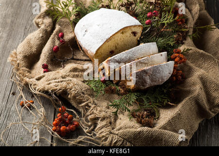 stollen on a wooden table, wrapped in burlap Stock Photo