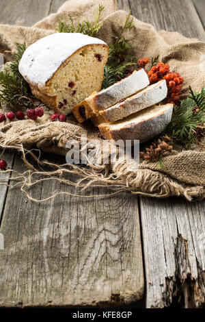 stollen on a wooden table, wrapped in burlap Stock Photo
