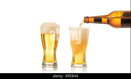 Bottle of beer pouring beer in a glass on white background Stock Photo