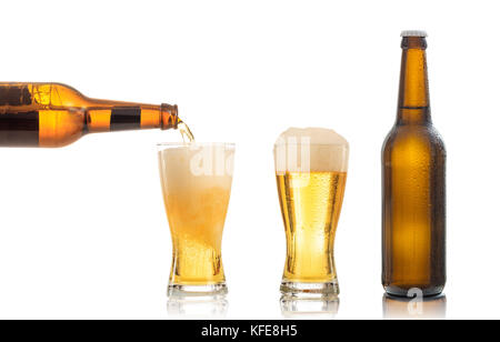 Bottles and glasses of beer on white background. Pouring beer into one glass Stock Photo