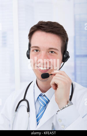 Closeup portrait of confident male doctor wearing headset in hospital Stock Photo