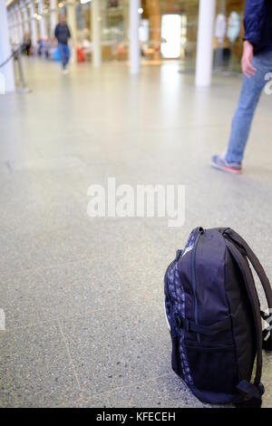 An abandoned backpack treated as a suspicious package in a busy public place Stock Photo