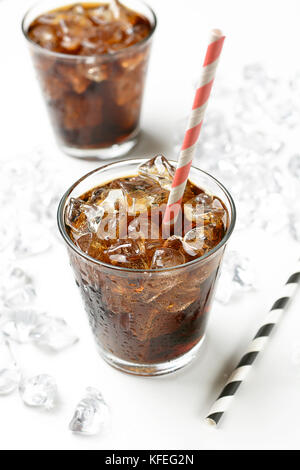 Cola with crushed ice in the glass on white background - closeup Stock Photo