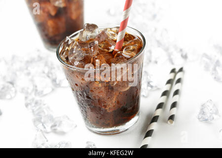 Cola with crushed ice in the glass on white background - closeup Stock Photo