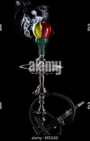 Smoking hookah with fruit head on dark background Stock Photo