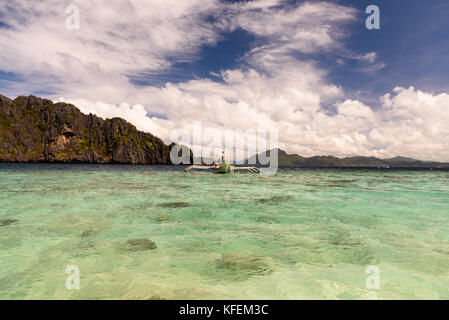 A typical Filipino boat in the middle of the sea near Shimizu Island, El Nido, Palawan Stock Photo