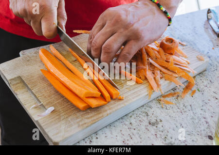 Cutting carrot in brunoise dice. Chef cooking. Types of cuts. Stock Photo