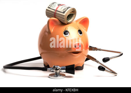 Cute Piggy Bank With Black Stethoscope and Dollar Banknotes Roll Isolated on White Background Stock Photo