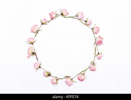 round frame of pink  flowers on white background.Pattern of red roses.Flat lay, top view Stock Photo