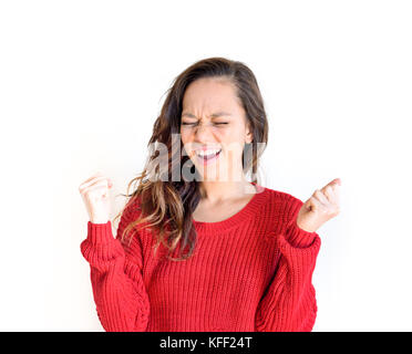 Young pretty asian teen woman in red dress closed eyes and clenched fists, concept of success, goal, victory portrait, isolated on white background Stock Photo