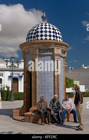 Urban view with emblematic monument 'El Morabito' and elders, Manzanilla, Huelva province, Region of Andalusia, Spain, Europe Stock Photo