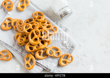 Salty Mini Pretzels with Salt in a Bowl - homemade organic snack for beer Stock Photo