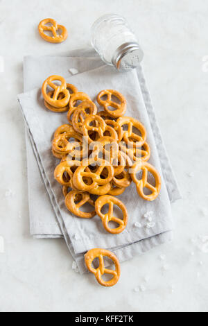 Salty Mini Pretzels with Salt in a Bowl - homemade organic snack for beer Stock Photo