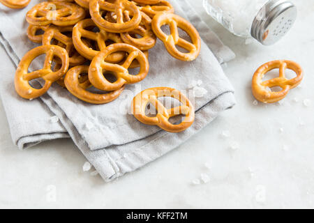 Salty Mini Pretzels with Salt in a Bowl - homemade organic snack for beer Stock Photo