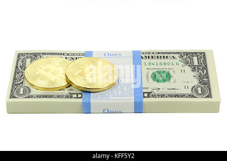 golden bitcoins on bundle of 1 US Dollar notes isolated on white background Stock Photo