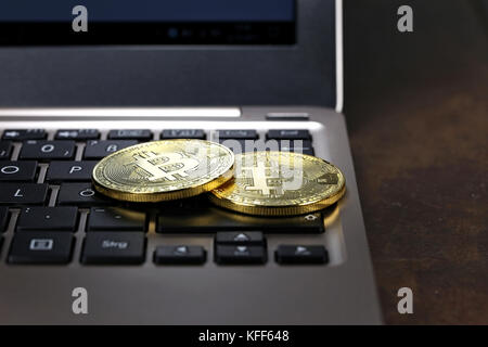 Bitcoins on a laptop keyboard Stock Photo