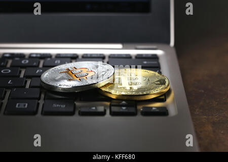 Bitcoins on a laptop keyboard Stock Photo