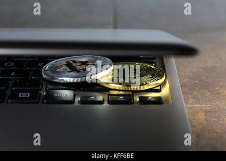Bitcoins on a laptop keyboard Stock Photo