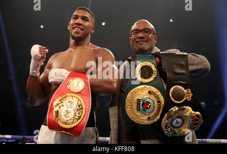 Anthony Joshua celebrates victory over Carlos Takam with his father Robert after the IBF World Heavyweight Title, IBO World Heavyweight Title and WBA Super World Heavyweight Title bout at the Principality Stadium, Cardiff. Stock Photo