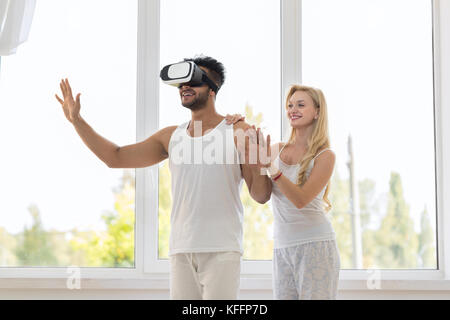 Hispanic Man Wear Virtual Reality Digital Glasses With Happy Smiling Girl Stock Photo