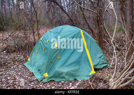 tent in foothills in dense thickets hidden. wild tourism is not a populated area Stock Photo