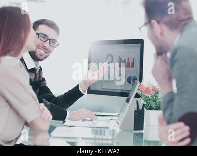 Closeup photo young business managers working with new startup project in office Stock Photo
