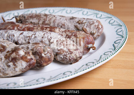 Traditional French artisan sausages on a vintage plate Stock Photo