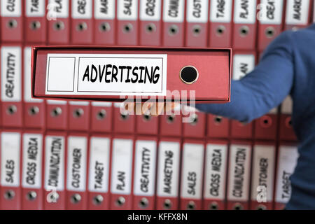 Advertising concept, young man holding ring binder. Stock Photo