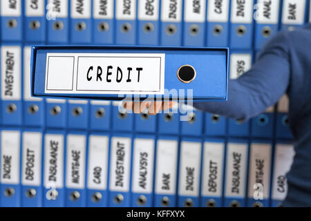 Credit card line investment balance concept. Young man holding ring binder. Stock Photo