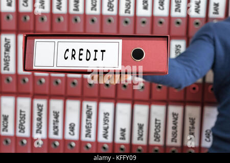Credit card line investment balance concept. Young man holding ring binder. Stock Photo