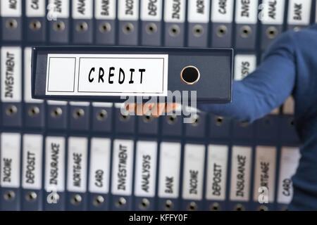 Credit card line investment balance concept. Young man holding ring binder. Stock Photo