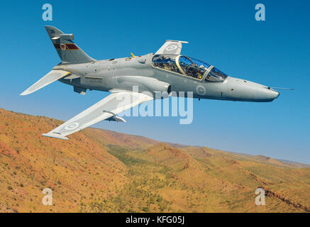 An air-to-air shot of a BAE Hawk jet trainer, from the Royal Australian Air Force base of RAAF Pearce, flying over a Western Australian landscape. Stock Photo