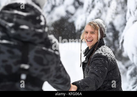 Young Man Couple Walking In Snow Forest Outdoor Guys Holding Hands Stock Photo