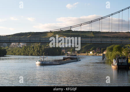 Barge Magnum passing under the suspension bridge over the Seine at Les Andelys, Normandy, France, Europe Stock Photo