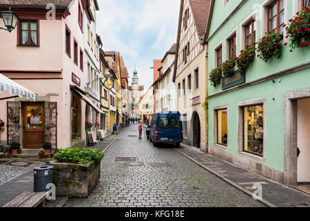 ROTHENBURG, GERMANY - OCTOBER 24, 2017: Unidentified pedestrants walk through a typical historic alleyway Stock Photo