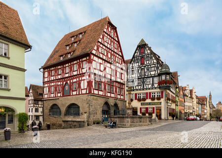 ROTHENBURG, GERMANY - OCTOBER 24, 2017: Unidentified tourists stroll along the historic main road or take a break Stock Photo