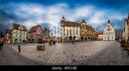 ROTHENBURG, GERMANY - OCTOBER 24, 2017: Few unidentified tourists and pedestriants enjoy the blue hour atmosphere on the historic market place Stock Photo