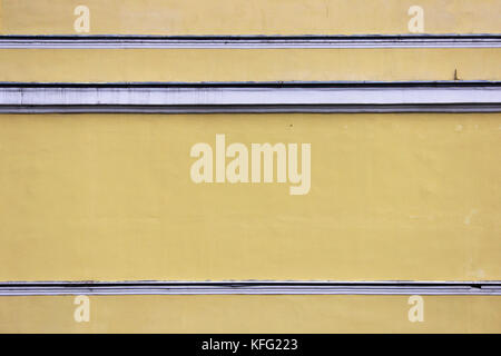 several horizontal white stripes on the background of beige plastered wall Stock Photo