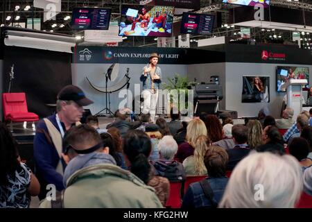 New York City, October 27, 2017 - Attendees at PDN PhotoPlus Expo 2017 listen to a photographic presentation at the Jacok K. Javits Convention Center. Stock Photo