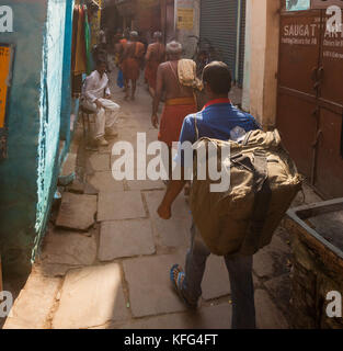 VARANASI, INDIA - 25 Oct 2016: Passerby walk through the alleyways on October 25, 2016 in Varanasi, India Stock Photo