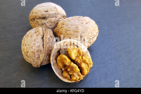 Walnut kernels and whole walnuts Stock Photo